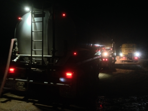Two water trucks at night